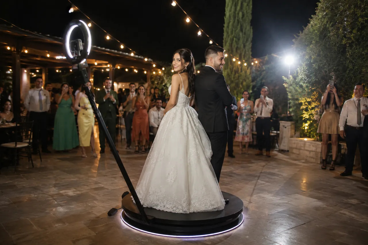 A bride on the 360 platform at an outdoor evening reception