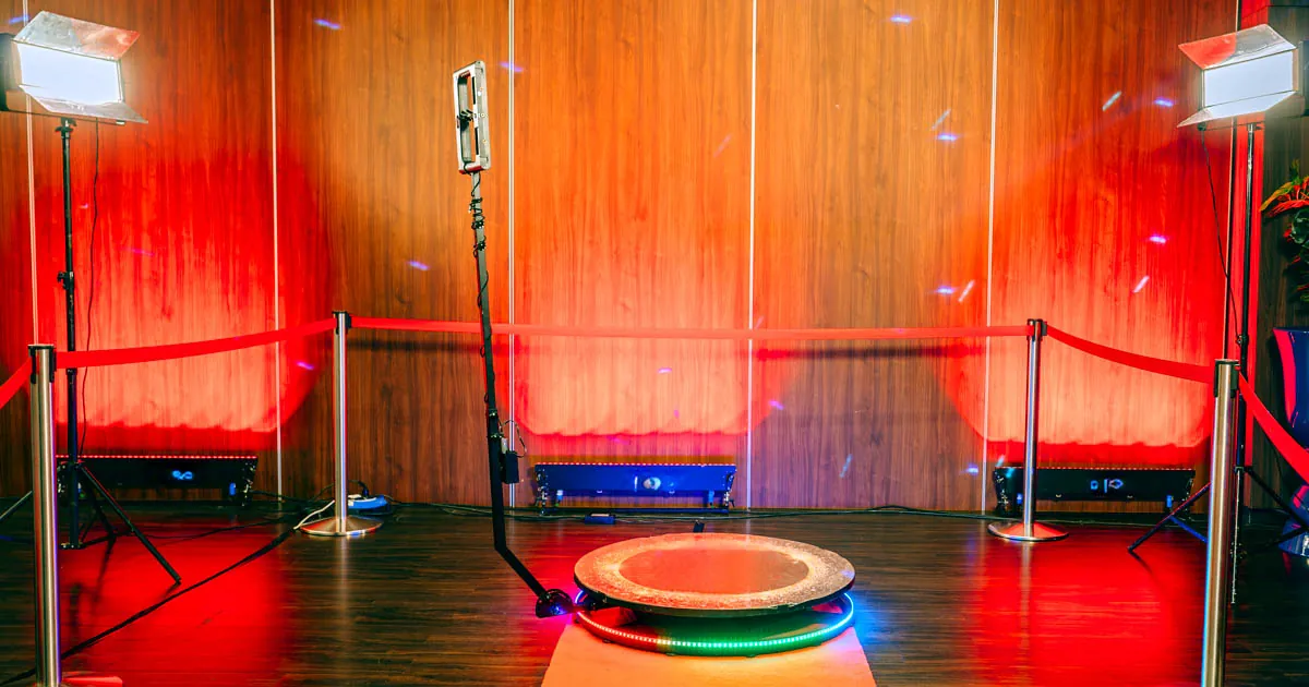 The 360 booth platform lit in red and blue