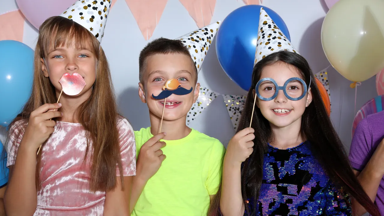 Kids posing with party props