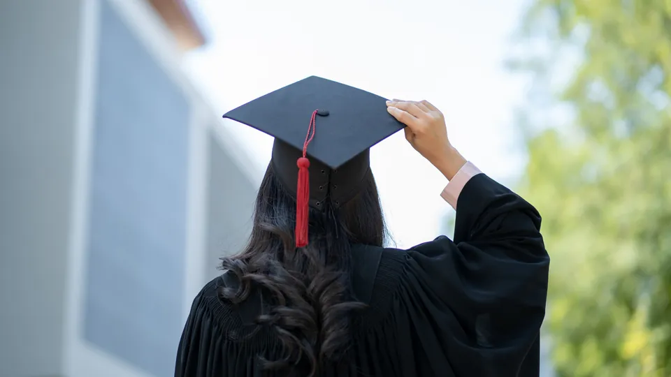 A graduate in a cap and gown